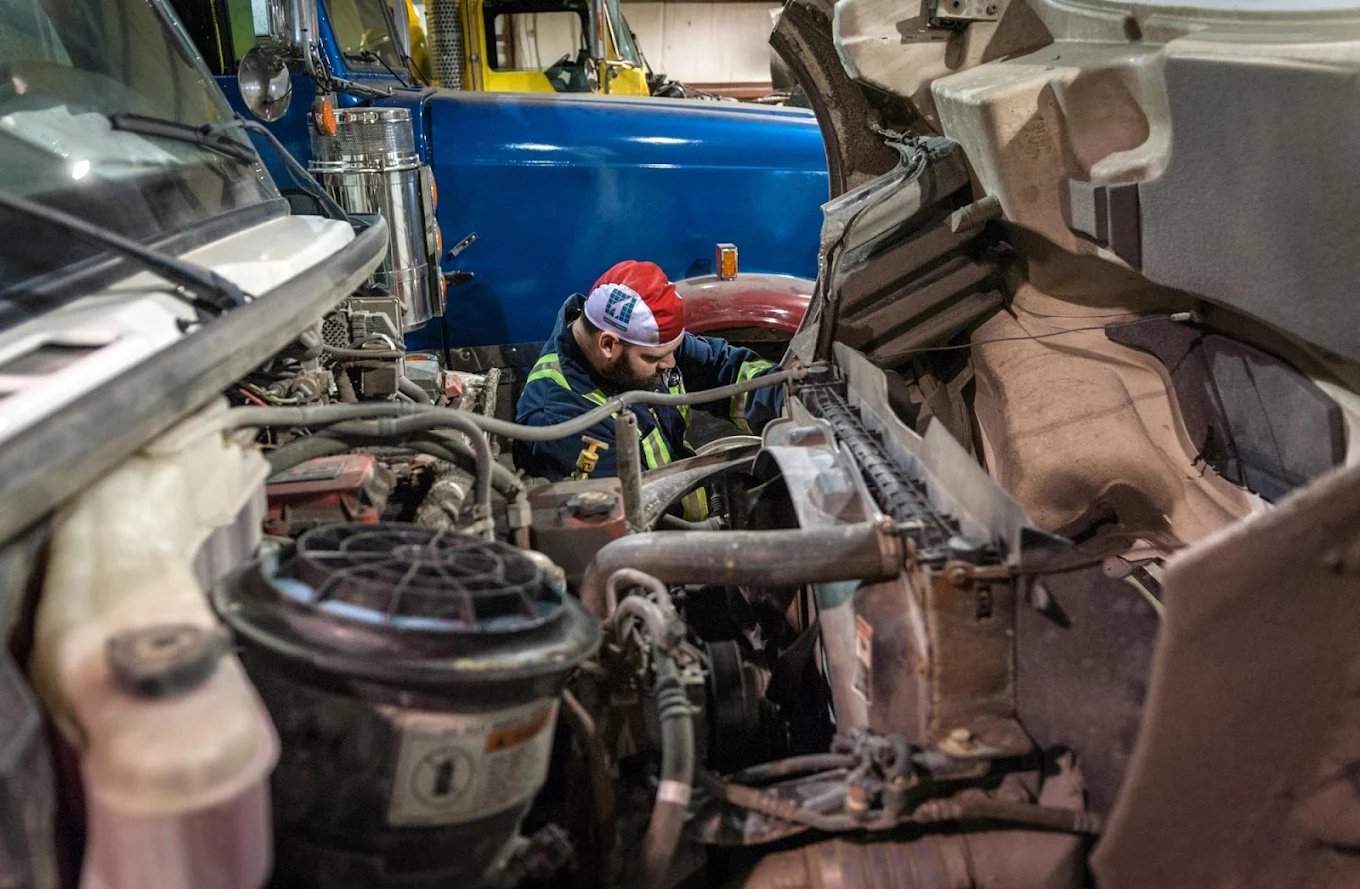 Atlantic Truck mechanic working under a heavy truck
